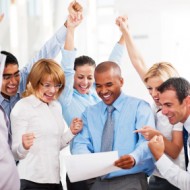 Cheerful businesspeople looking at the report.